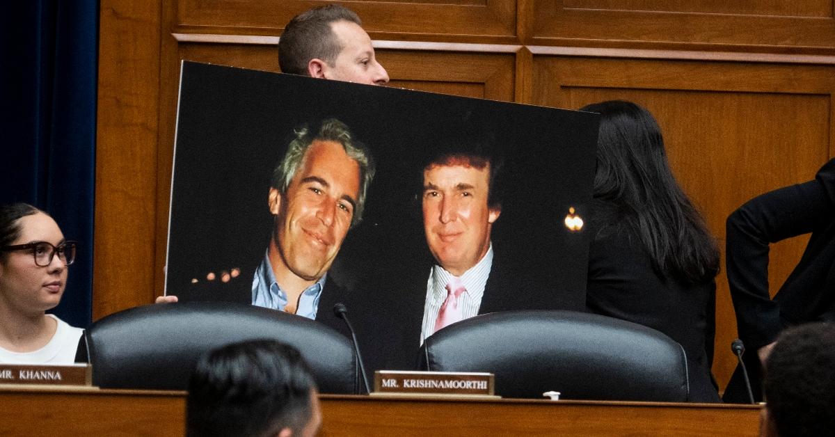 Rep. Jared Moskowitz holds a photo board featuring a photo of Jeffrey Epstein with Donald Trump