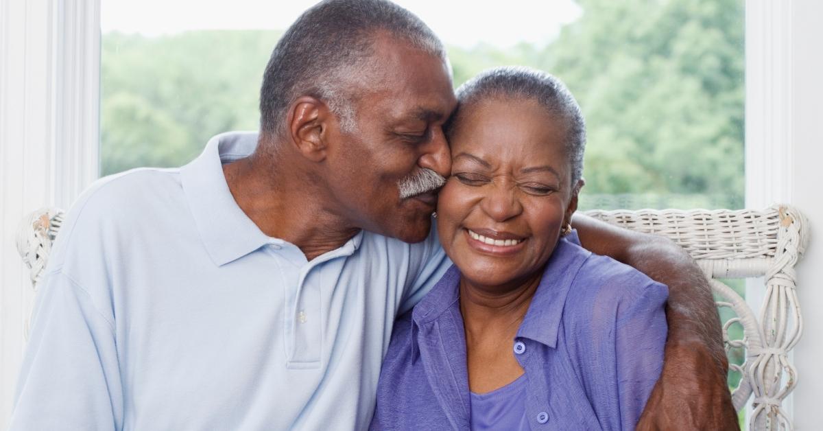 older couple Man kissing wife