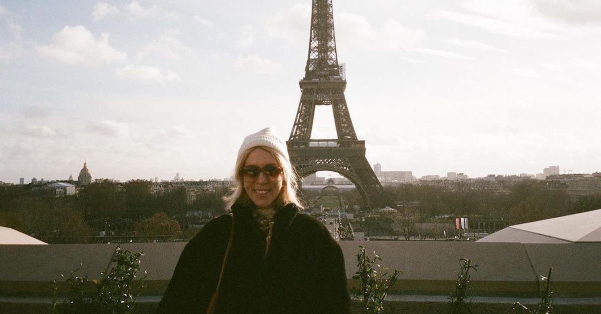 Eden McCoy's mom standing in front of the Eiffel Tower in Paris