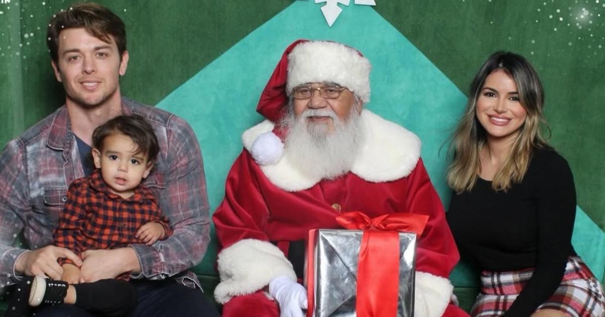 Chad Duell with his wife and son pose for a picture with Santa