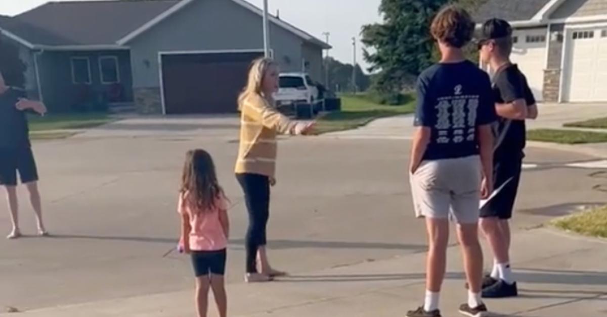 A couple cusses at kids playing basketball