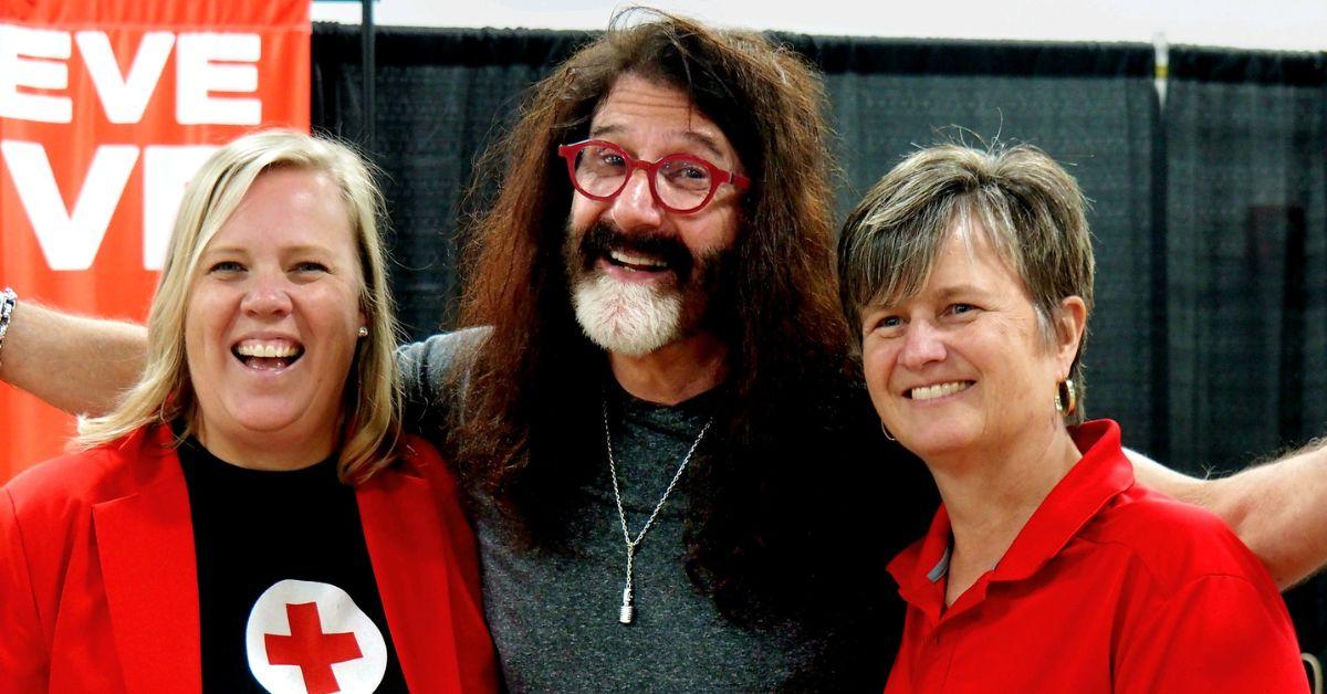 Pierre Robert with two Red Cross volunteers.