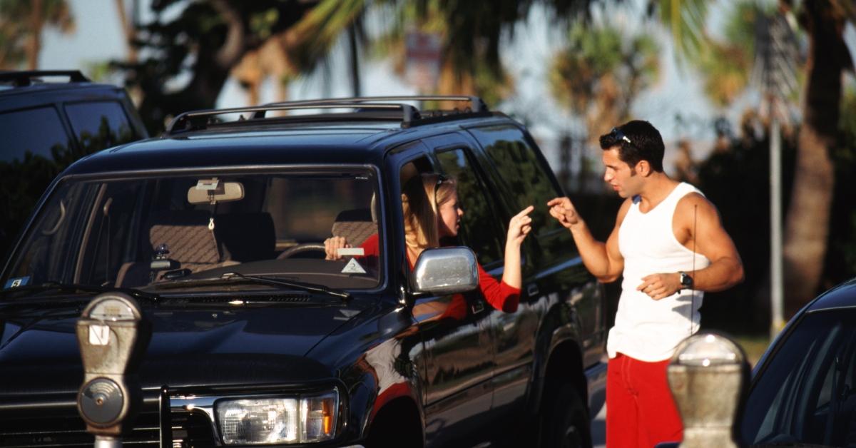 woman in car fighting with man