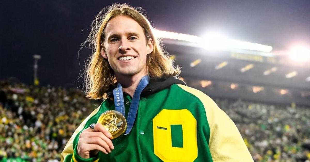 Cole Hocker with his gold medal at a Ducks game.