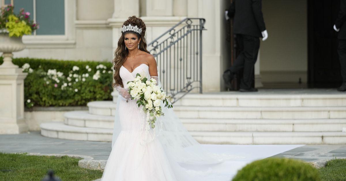 Teresa Giudice walking down the aisle on her wedding day in a white mermaid gown.