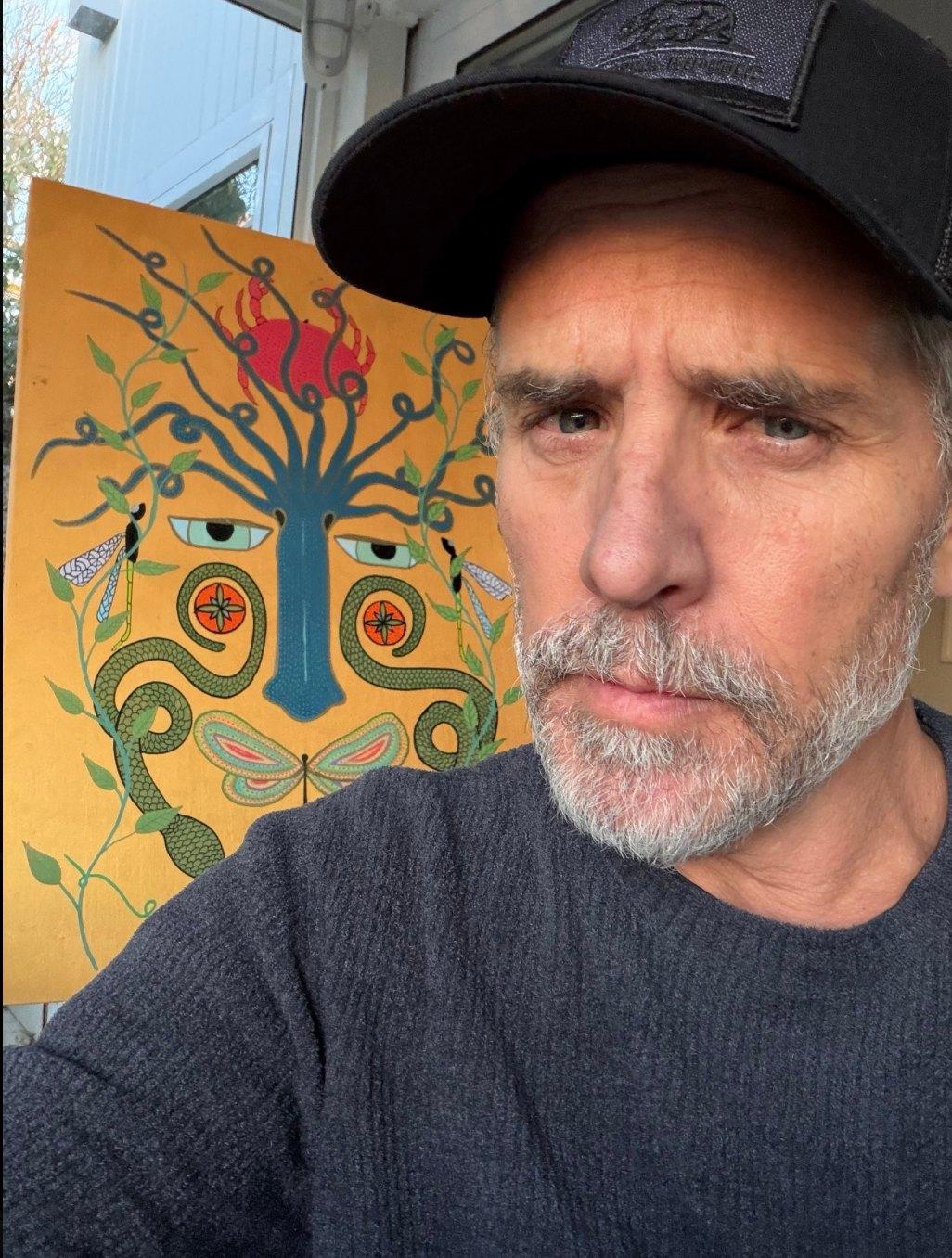 Hunter Biden next to artwork.