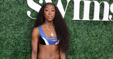 Flau'jae Johnson attends the 2023 Sports Illustrated Swimsuit Issue Launch at Hard Rock Hotel New York on May 18, 2023 in New York City. wearing a blue, white, and black sports bra.
