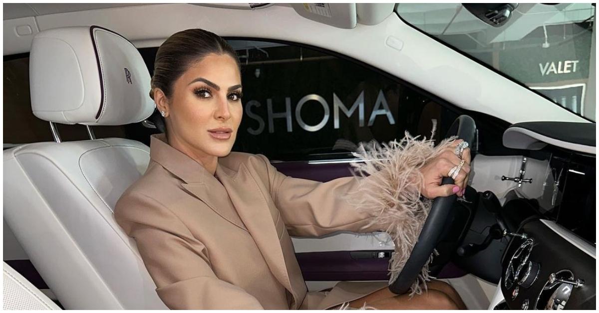 Stephanie Shojaee posing in her car