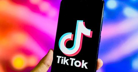 TikTok logo on a phone in a person's hand.