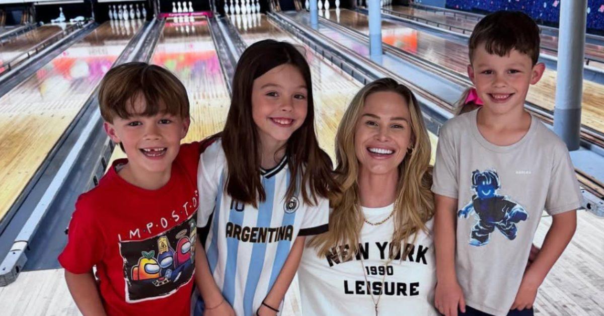 Meghan King with her three kids at a bowling alley.