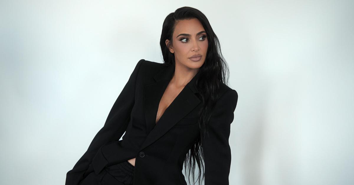 Kim Kardashian poses in a black suit in the Season 5 premiere of 'The Kardashians.'