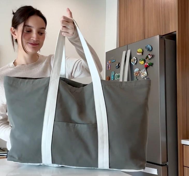 Emily Mariko posing with her new tote bag in a TikTok