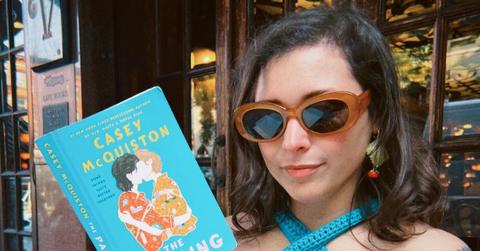 Casey McQuiston holding The Pairing