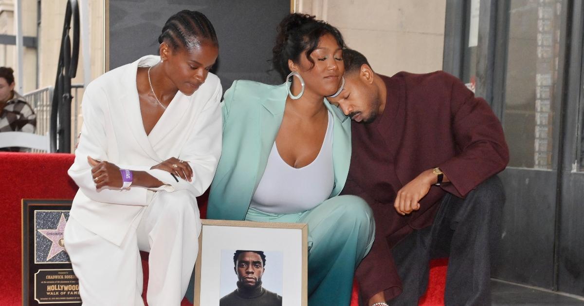 Letitia Wright (L), Chadwick Boseman's widow Taylor Simone Ledward (C) and Michael B. Jordan (R) embrace over Chadwick's Walk of Fame star