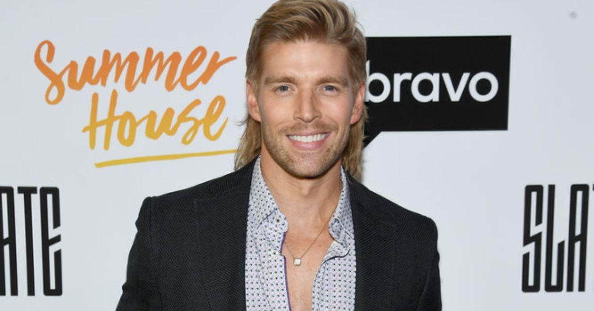 Kyle Cooke smiling for photo in front of step and repeat
