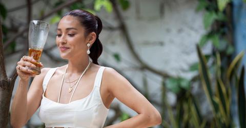 Shay Mitchell drinking a pint of beer in 'Thirst'