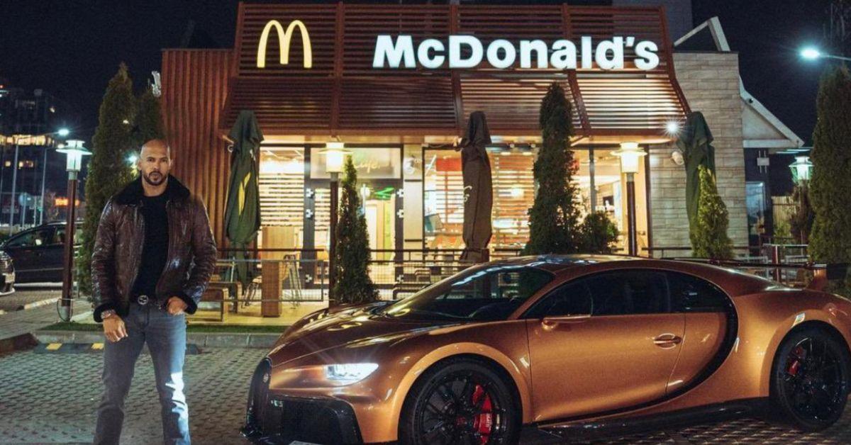 Andrew Tate standing with a sports car in front of McDonald's. Cool. 