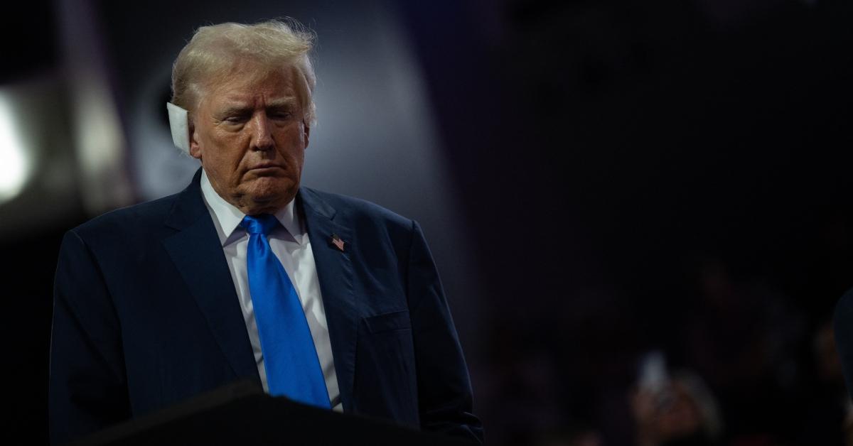 Donald Trump at a political event with a bandage on his ear.