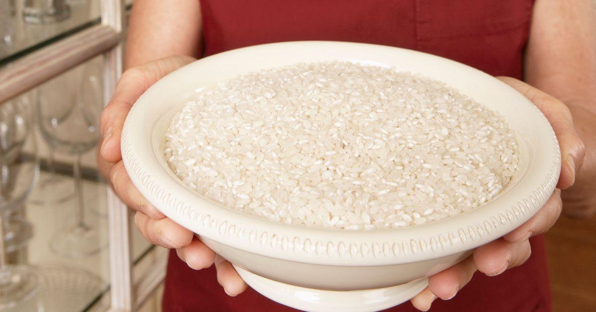 A woman holding a bowl of rice