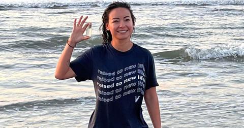 Mica Miller in a blue tee shirt with the ocean in the background