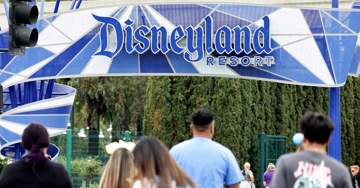 People walk toward an entrance to Disneyland on April 24, 2023 in Anaheim, California. 