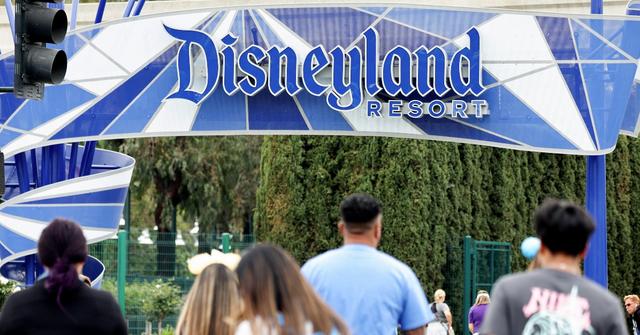 People walk toward an entrance to Disneyland on April 24, 2023 in Anaheim, California.