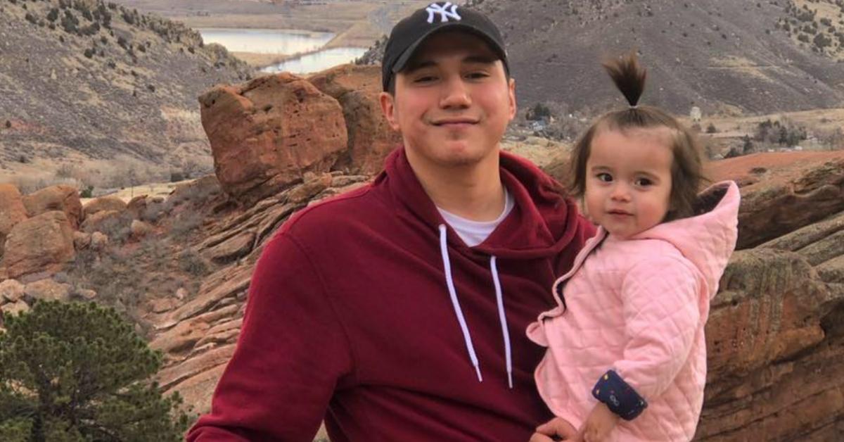 Ashton Matheny and his daughter pose in front of rocks in a desert