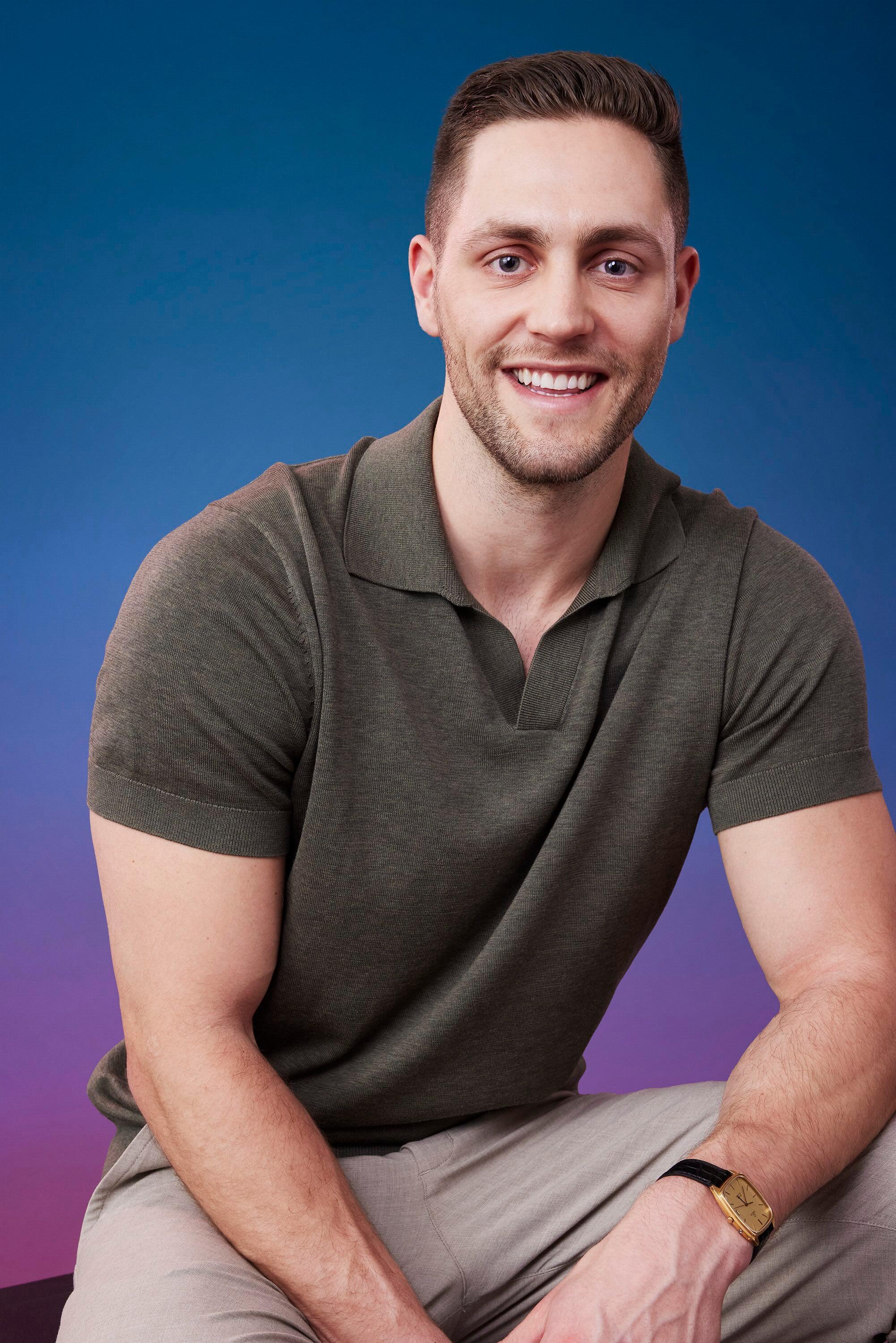 Brendan poses in front of a blue-purple ombré background for his official 'The Bachelorette' Season 21 portrait.