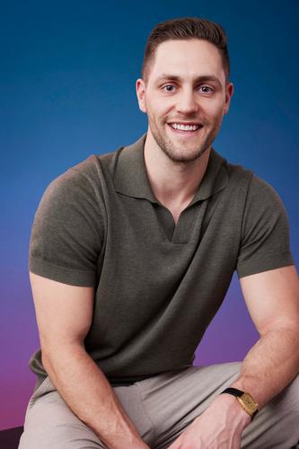 Brendan poses in front of a blue-purple ombré background for his official 'The Bachelorette' Season 21 portrait.