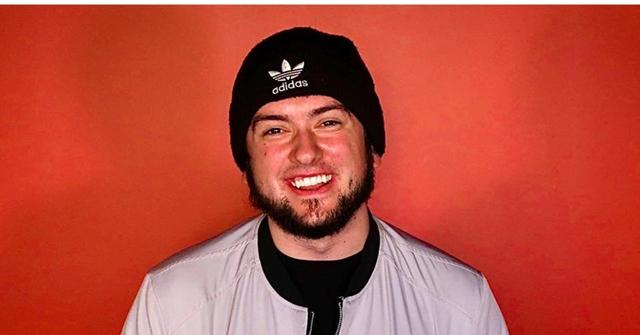 Drake Webb wearing a silver jacket a black beanie