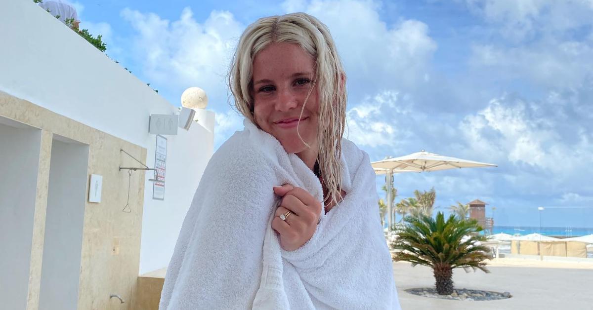 Jack Blocker's wife, Georgia, smiles for the camera while wrapped in a beach towel.