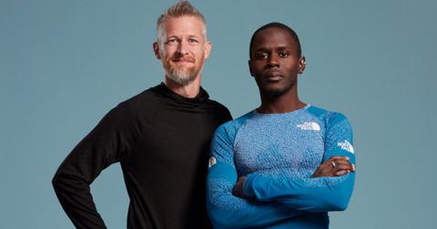 Jeff and Coree stand in front of a blue background for Race to Survive: New Zealand