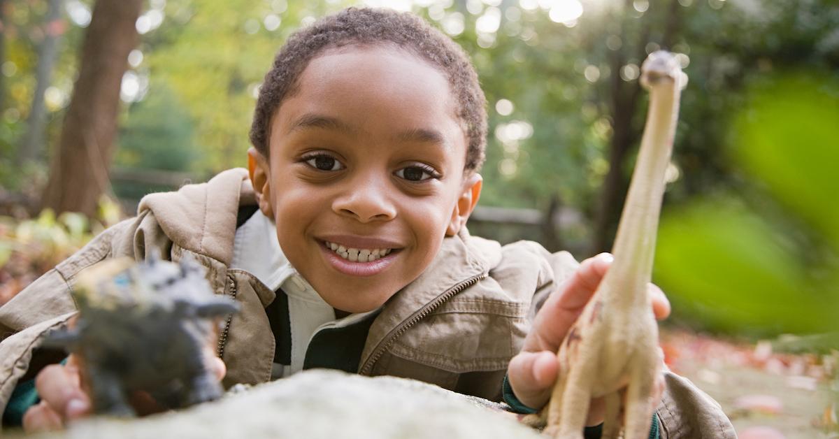 kid playing with dinosaurs