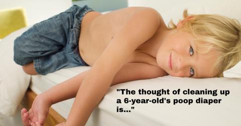 A child who is smiling on a sofa