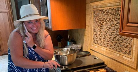 Amy Hauser talking on the phone and cooking