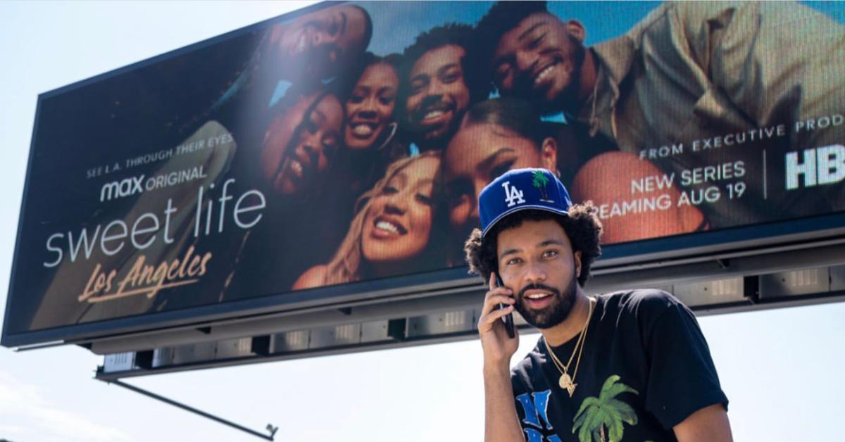 PJ Compton in front of a poster for HBO Max's 'Sweet Life'