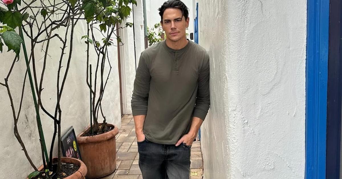 Tom Sandoval leans against a wall in Big Sur