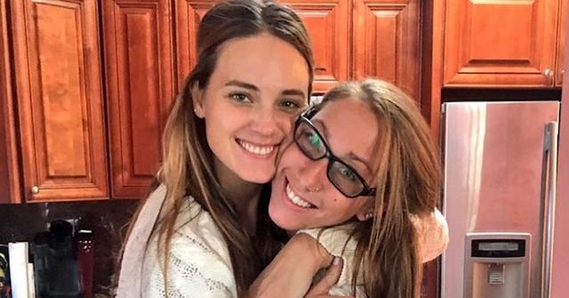 Nicole and Laurel hug in a kitchen