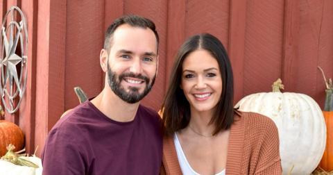 Desiree Hartsock and Chris Siegfried pose with pumpkins in the fall