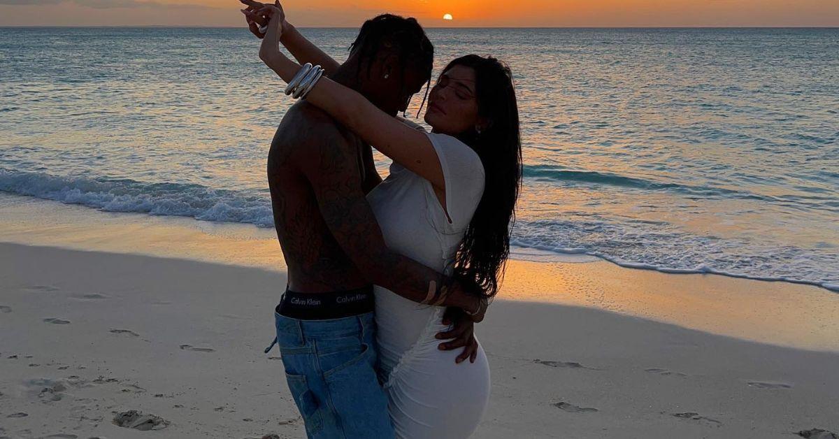 (l-r): Travis Scott and Kylie Jenner hugging on the beach.