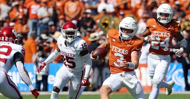 Quarterback Quinn Ewers #3 of the Texas Longhorns runs the ball as he is pursued by Kendel Dolby #15 of the Oklahoma Sooners at the Cotton Bowl on Oct. 7, 2023, in Dallas, Texas.