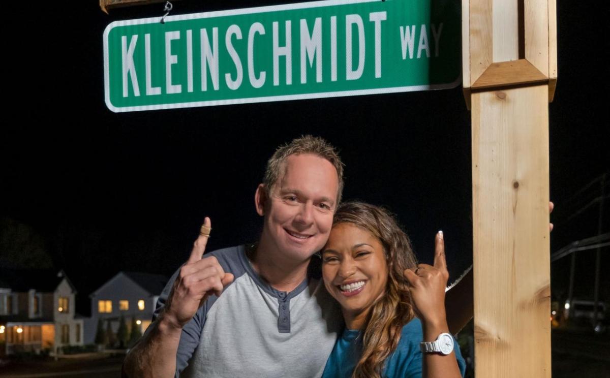 Brian and Mika Kleinschmidt point to their street sign on 'Rock the Block'