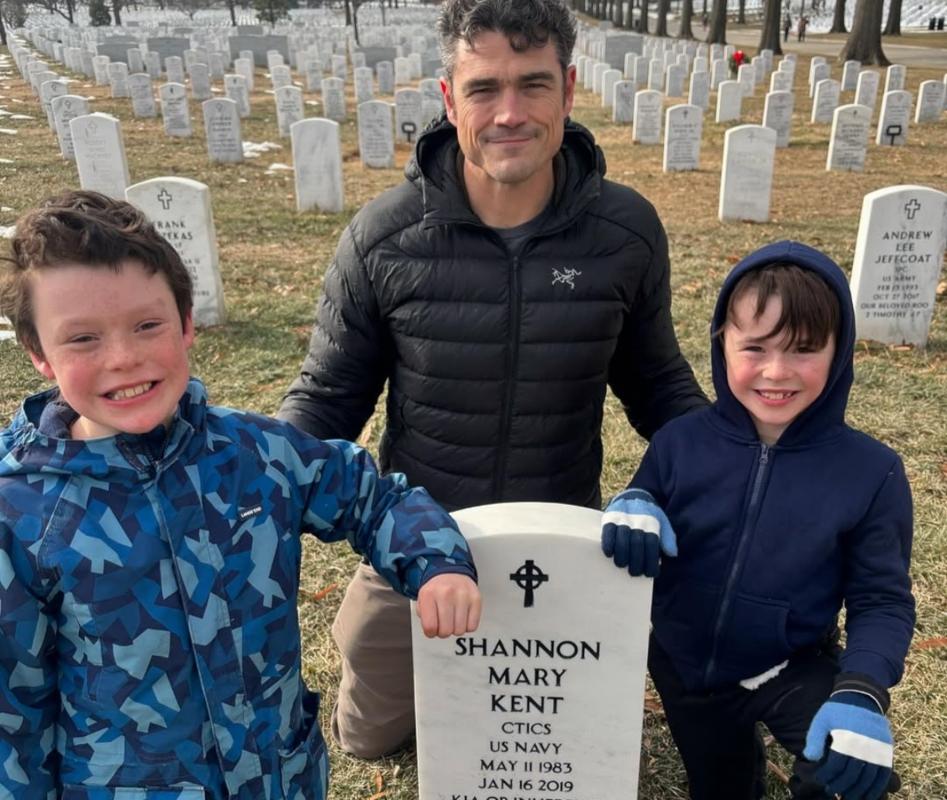 Joe Kent with his kids at his first wife's headstone at Arlington National Cemetary