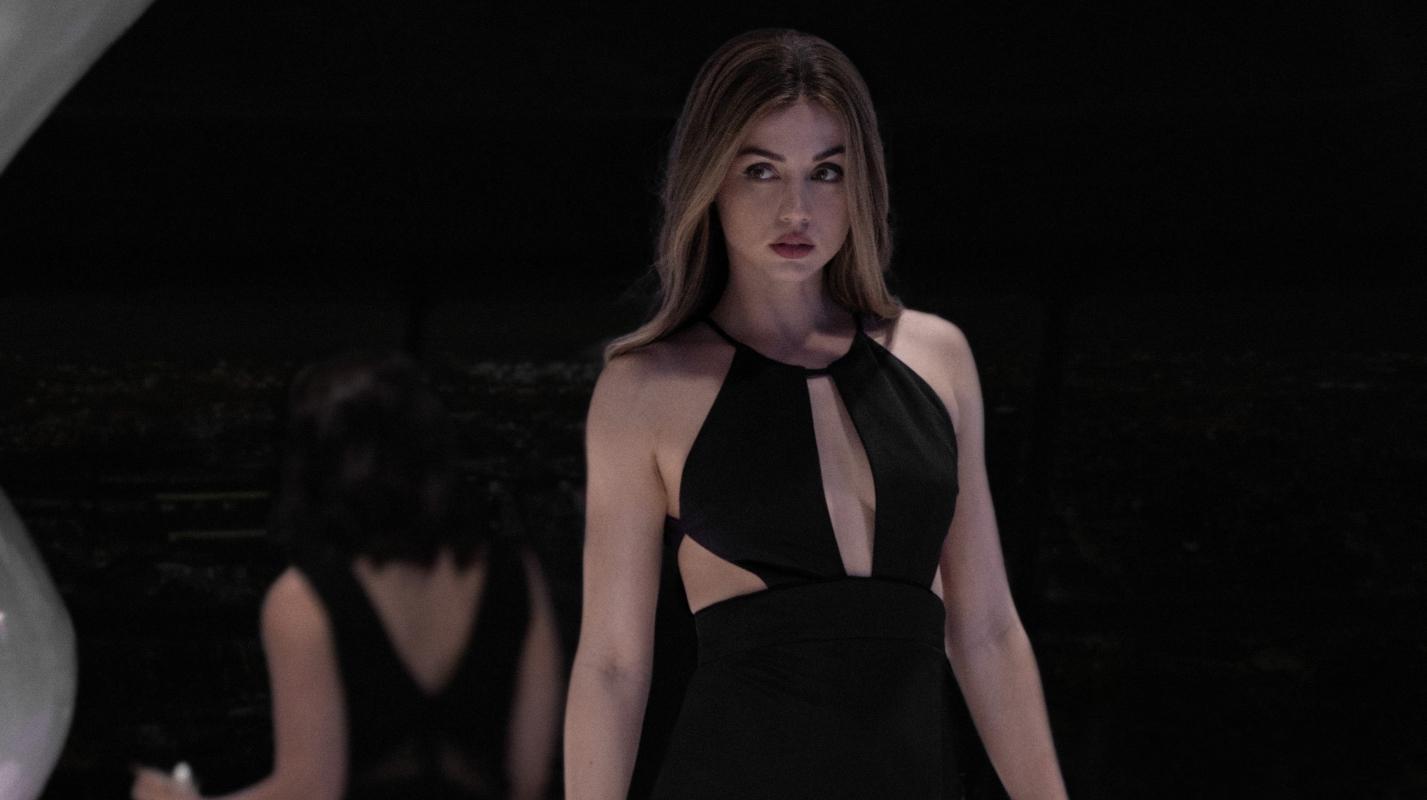 Ana de Armas as Sadie in Apple TV+'s 'Ghosted', wearing a black cutout dress.