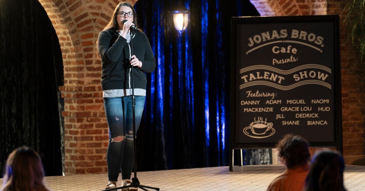 Naomi on-stage for the talent show on Claim to Fame