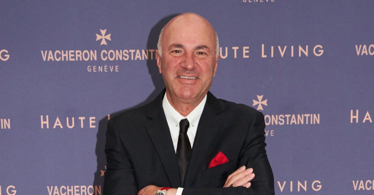 Kevin O'Leary posing in front of a purple background with his arms folded at The Four Seasons Hotel on May 04, 2022 in Miami, Florida. 