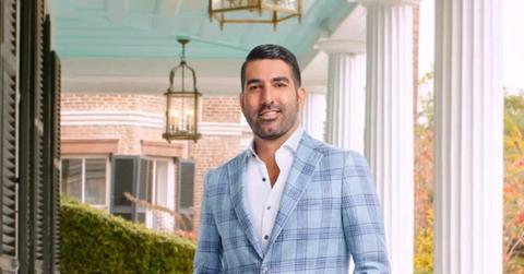 Rod Razavi on a porch in a blue plaid suit