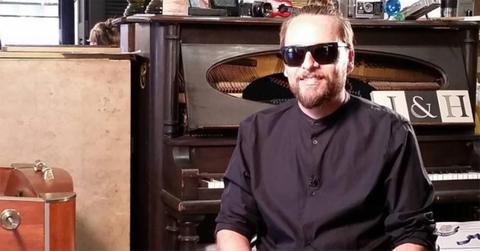 Adrian Olivares sitting with sunglasses on.