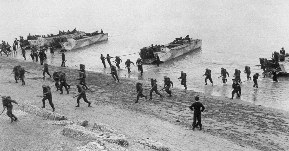 Troops running up the beach on D-Day. 