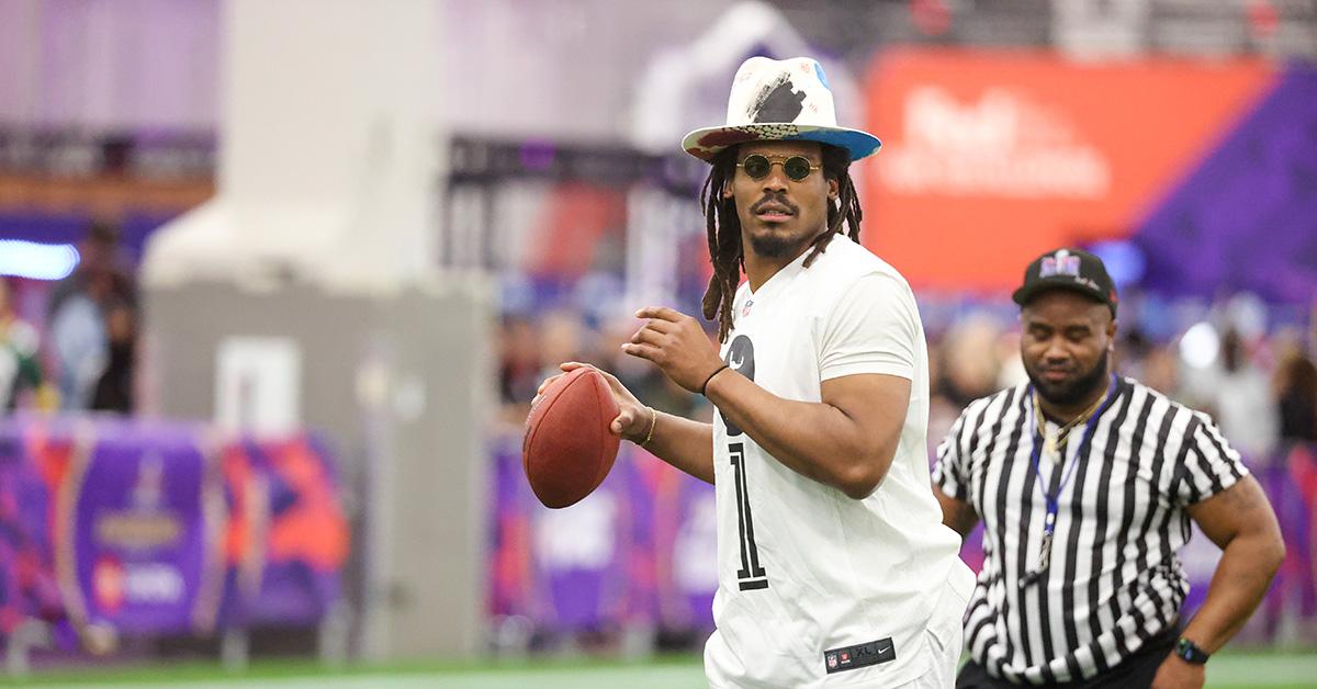 Cam Newton throwing a football during a flag football event. 